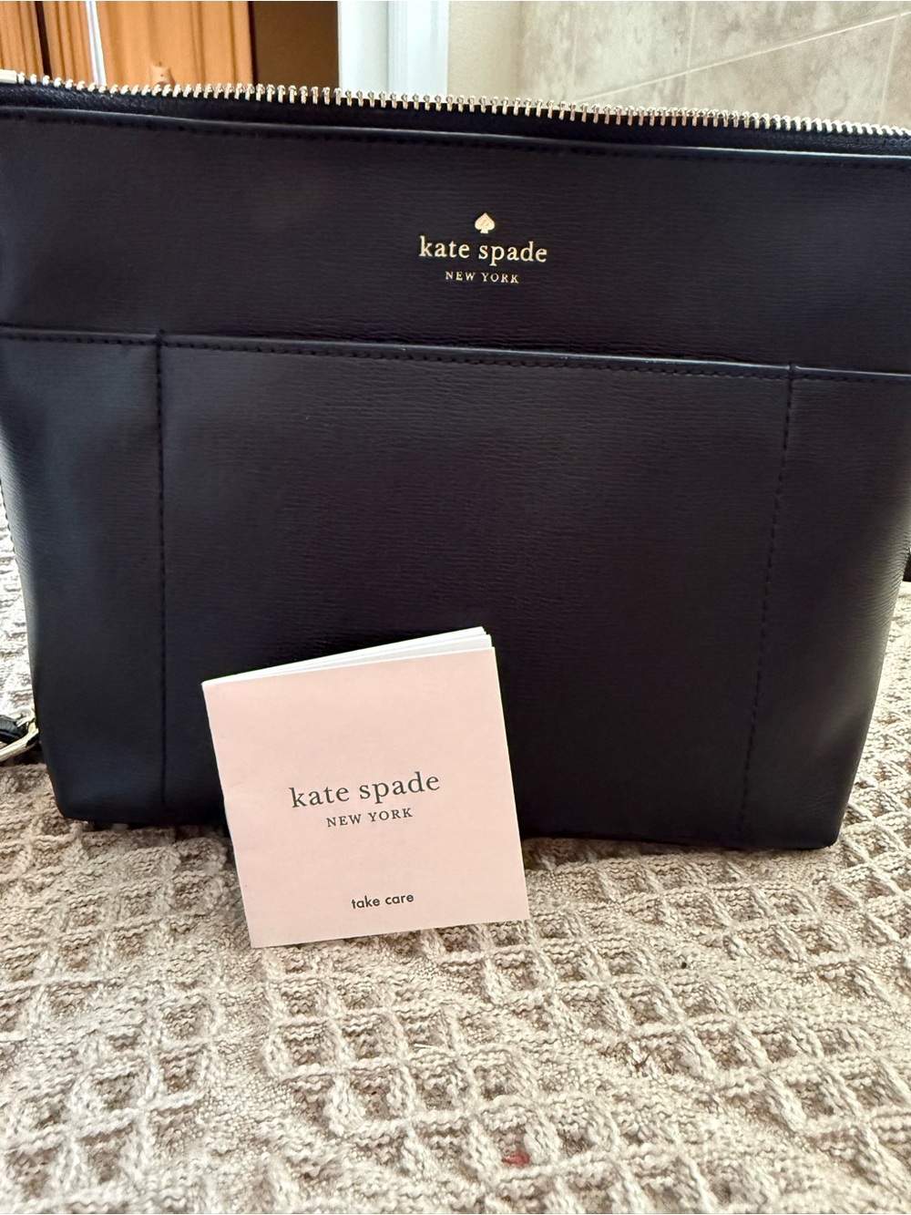 kate spade black leather tote with gold logo